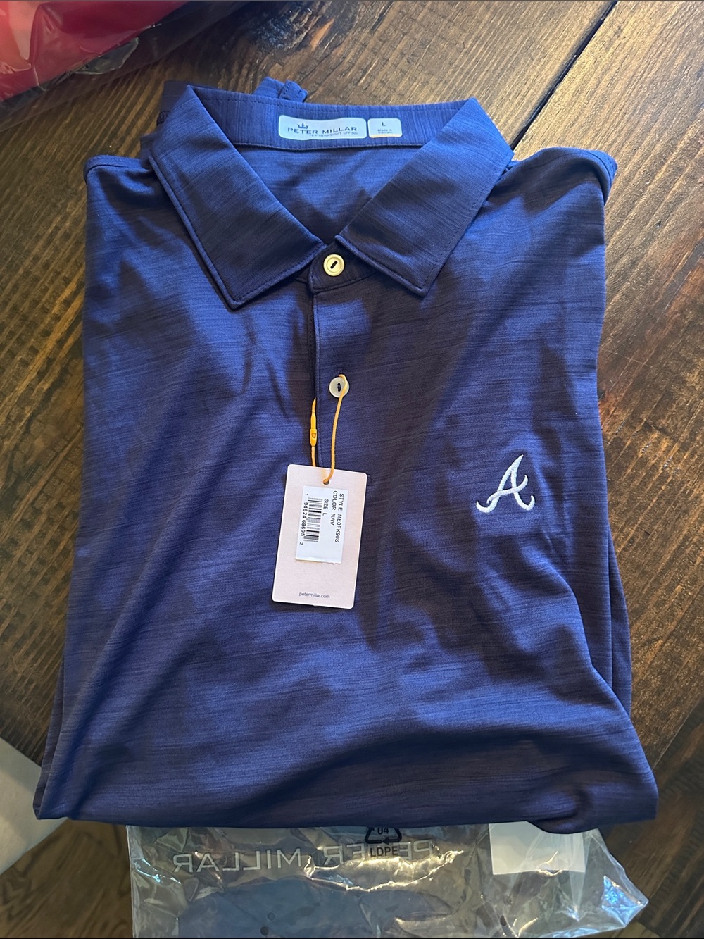 New with tags mens Atlanta Braves Peter Millar polo. Navy size large